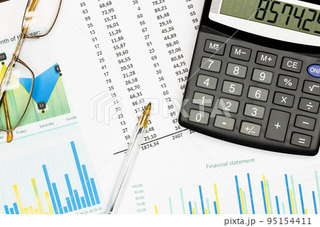 Top view office table desk. Financial report. Flat lay. Workspace with Business office supplies, Accounts number on the data paper, pen, glasses, calculator on the table. Top view. Close-up Top view office table desk. Financial report. Flat lay. Workspace with Business office supplies, Accounts number on the data paper, pen, glasses, calculator on the table. Top view. Close-up 95154411