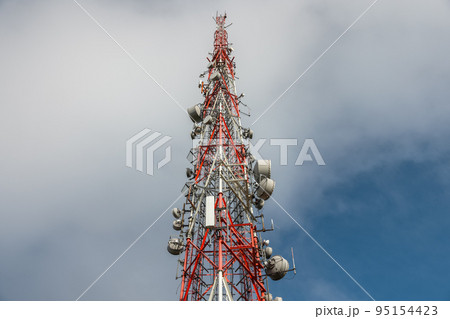 Large transmission tower against deep blue sky and clouds Large transmission tower against deep blue sky and clouds 95154423