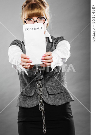 businesswoman with chained hands holding contract 95154987