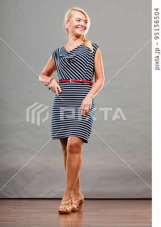 Mid adult woman in summer striped dress 95156504