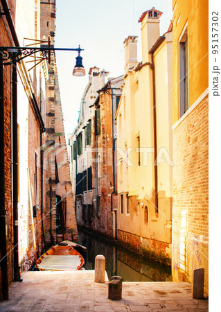 Boat moored between colorful houses 95157302