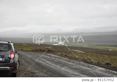 Gray SUV on a gravel road in Iceland 95157452