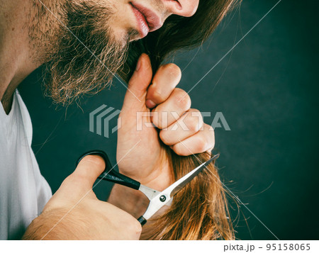 Male hands cutting long hair Male hands cutting long hair 95158065