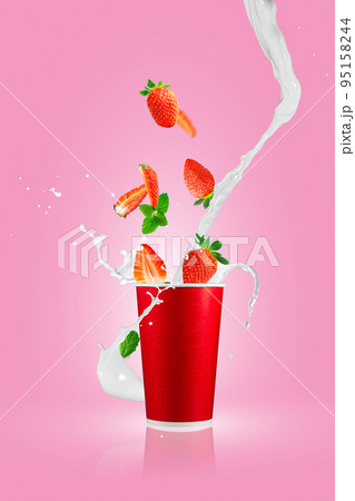 Strawberry berries falling in paper takeaway cup with milk splashes. Strawberry smoothie splash. 95158244
