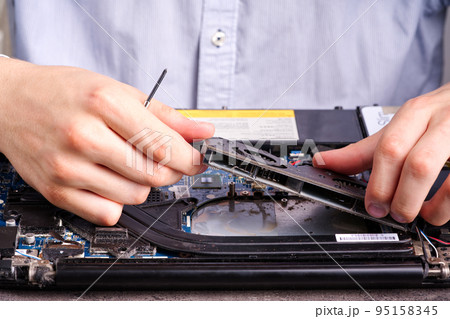 Hands fixing motherboard of pc or laptop notebook close up in service. Laptop repair service. 95158345