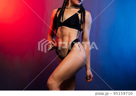 Close-up shot of young woman waist with muscular abdominal muscles. Abs of fit female athlete. Close-up shot of young woman waist with muscular abdominal muscles. Abs of fit female athlete. 95159710