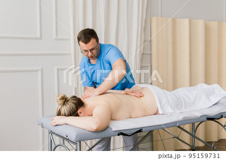 Young fat woman getting massage treatment in day spa cabinet. 95159731