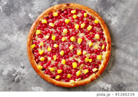 Sweet pizza with red currants, pineapple on melted mozzarella with condensed milk on gray surface 95160239