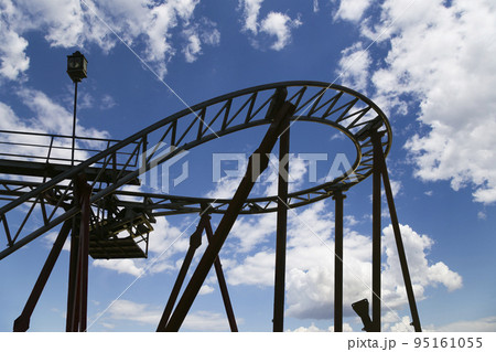 Attraction roller-coaster (switchback) on the background of the cloudy sky Attraction roller-coaster (switchback) on the background of the cloudy sky 95161055