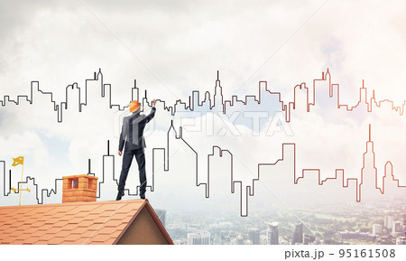 Man architect draw silhouette of modern city on blue sky. Mixed Man architect draw silhouette of modern city on blue sky. Mixed 95161508