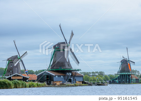 Three Dutch Windmills on the River Bank Three Dutch Windmills on the River Bank 95161545