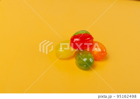 Colorful Hard Candies on Yellow Texture Background 95162498