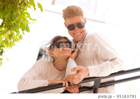 Happy cheerful couple in sunglasses Happy cheerful couple in sunglasses 95163791