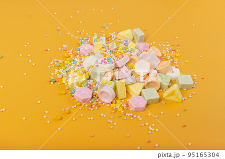 Tablet Candies on Yellow Background, Compressed Tablets 95165304