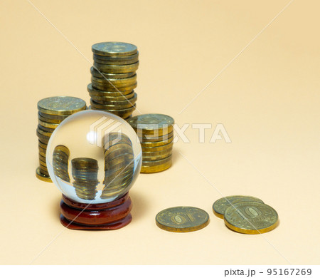 Pyramids of coins are reflected in a glass ball. Pyramids of coins are reflected in a glass ball. 95167269