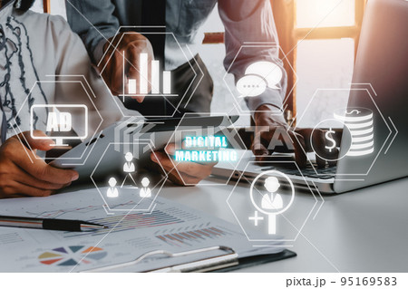 Digital marketing technology concept, Businessteam discussing data on office desk with VR screen digital marketing icon on office desk, Internet, Online, Search Engine Optimisation. 95169583