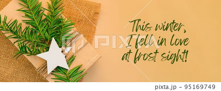 This winter, I fell in love at frost sight Inspiration joke quote phrase Box with New Year's gifts, wrapped in craft paper and decorated with fir branch. Holidays Banner  95169749