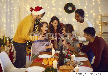 Happy diverse friends cheers celebrating New Year 95174162