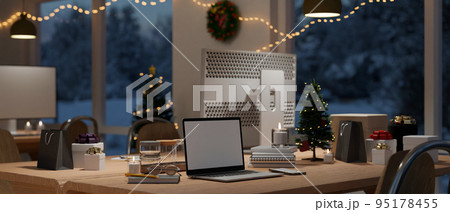 Modern urban office with Christmas decoration at night interior with computer desk Modern urban office with Christmas decoration at night interior with computer desk 95178455