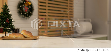 Marble kitchen countertop with copy space, bread and Christmas tree. close-up image 95178463
