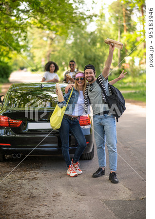 Cute young couple looking excited and joyful standing near the car 95183946