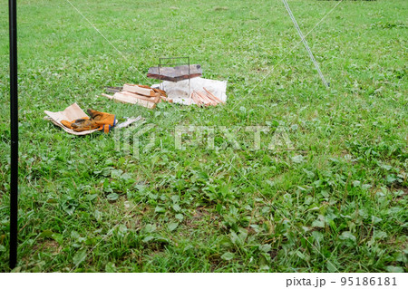 芝生のキャンプ場と焚き火用の薪 95186181