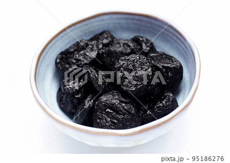 Dried prunes on white background Dried prunes on white background 95186276