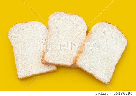 Sliced bread on yellow background. Sliced bread on yellow background. 95186290