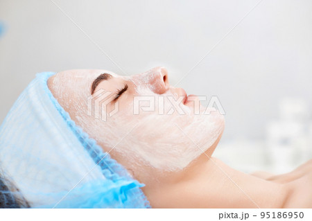 beautiful woman with blue alginate mask on face beautiful woman with blue alginate mask on face 95186950
