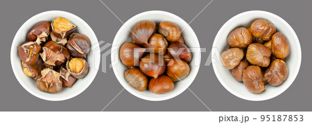 Unshelled, roasted and boiled chestnuts, marrons in white bowls over gray. Sweet chestnuts, Castanea sativa, eaten raw, candied, cooked, milled into flour, or roasted as warm snack, sold on streets. Unshelled, roasted and boiled chestnuts, marrons in white bowls over gray. Sweet chestnuts, Castanea sativa, eaten raw, candied, cooked, milled into flour, or roasted as warm snack, sold on streets. 95187853