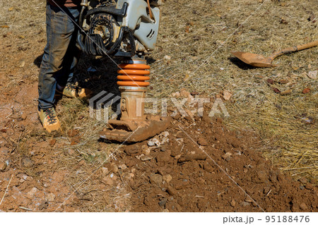 Tamping machine compactor tool vibratory plate jumping at compacting to ground in under construction 95188476