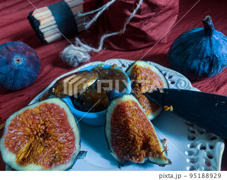 Breakfast variant with butterbroads and fruits such as plums, figs and homemade bread and figs jam and coffee. Natural light used only 95188929