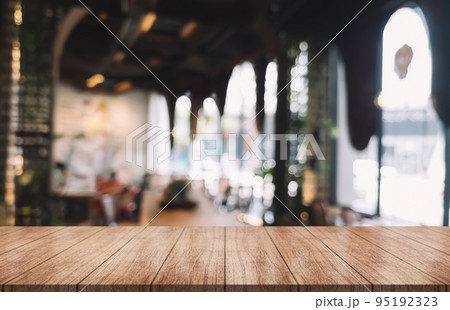 Empty wooden table top with lights bokeh on blur restaurant background.	 95192323