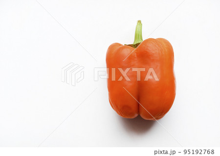 Orange large pepper fruit on a white background. Beautiful ripe pepper close-up. Orange large pepper fruit on a white background. Beautiful ripe pepper close-up. 95192768