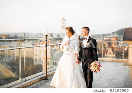 Wedding couple holding hands, groom and bride together on wedding day 95192999