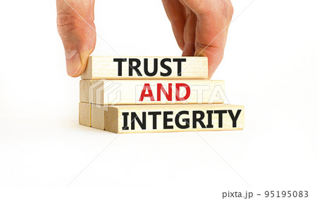 Trust and integrity symbol. Concept words Trust and integrity on wooden blocks. Businessman hand. Beautiful white background. Business, psychological and trust and integrity concept. Copy space. 95195083