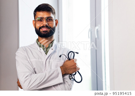 indian pet doctor wearing uniform and holding a stethoscope 95195415