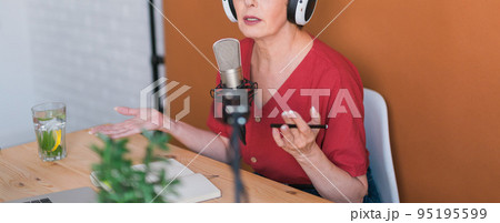 Banner Close up woman making podcast recording for her online show. Attractive business woman using headphones front of microphone for a radio broadcast Banner Close up woman making podcast recording for her online show. Attractive business woman using headphones front of microphone for a radio broadcast 95195599