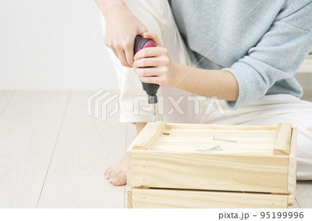 室内でDIYする女性 95199996
