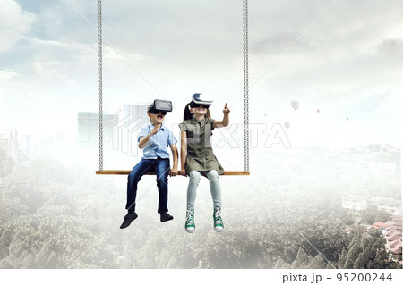 Kids wearing virtual reality goggles Kids wearing virtual reality goggles 95200244