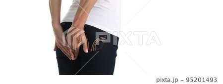 Woman holds hands on anus with stomach problems 95201493