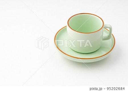 A green ceramic tea cup isolated on white background A green ceramic tea cup isolated on white background 95202684