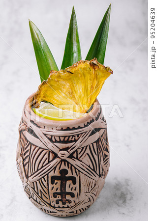 Tropical pineapple cocktail drink with lime Tropical pineapple cocktail drink with lime 95204639