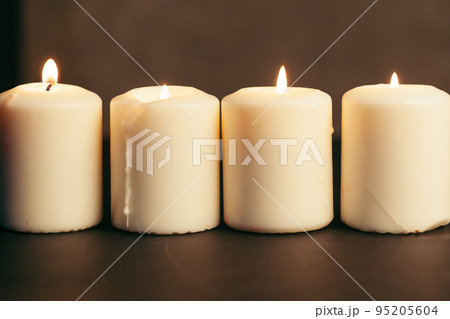 Candle flame close up on a black background Candle flame close up on a black background 95205604