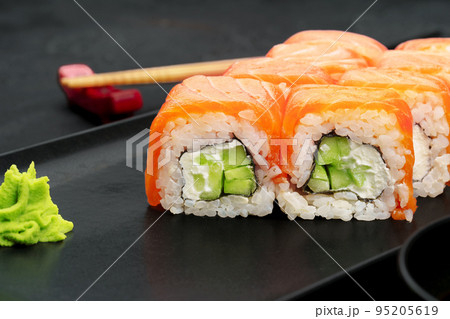 Fresh philadelphia sushi roll served on black plate Fresh philadelphia sushi roll served on black plate 95205619
