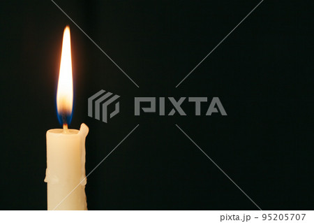 Candle flame close up on a black background 95205707