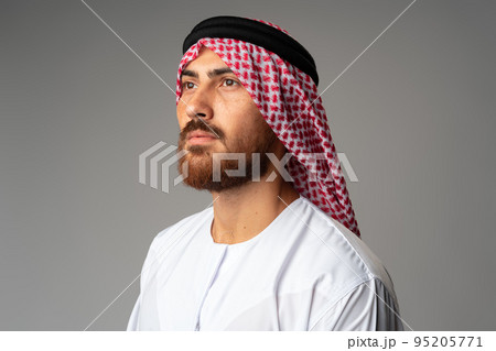 Portrait of young Arab man on gray background in studio 95205771