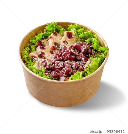 Salad with lettuce, chicken fillet, baked mushrooms and red beans with teriyaki sauce and sesame in paper bowl on white 95206432