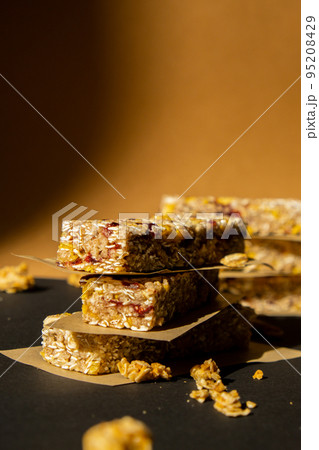 Homemade Granola energy bar. Variety of homemade protein granola breakfast bars, with nuts, raisins dried cherries and chocolate. Healthy nutrition eating Gluten free cereal dieting snack super food Homemade Granola energy bar. Variety of homemade protein granola breakfast bars, with nuts, raisins dried cherries and chocolate. Healthy nutrition eating Gluten free cereal dieting snack super food 95208429