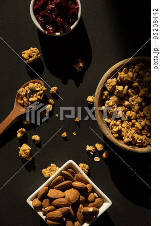 Homemade granola with nuts and seed. Healthy snack on breakfast. Muesli from oatmeal, raisins, honey, cranberry, flax, almond, cashew, freshly baked  95208442